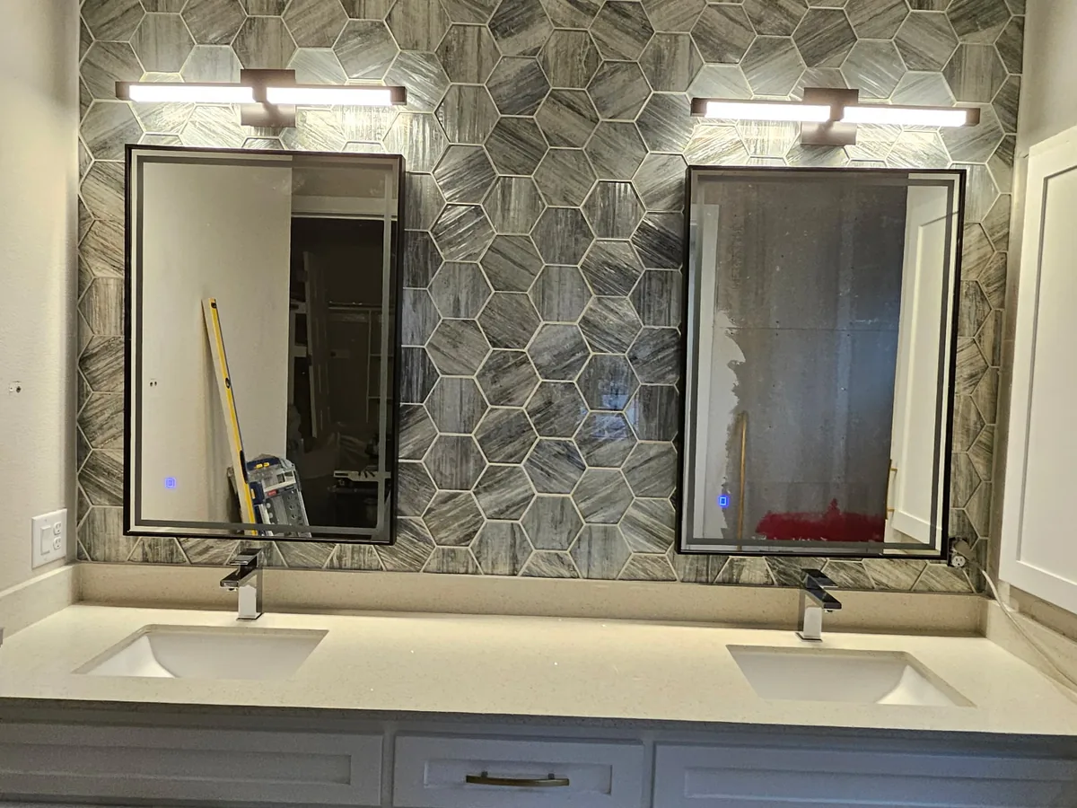 Double vanity with hexagon marble tile accent wall