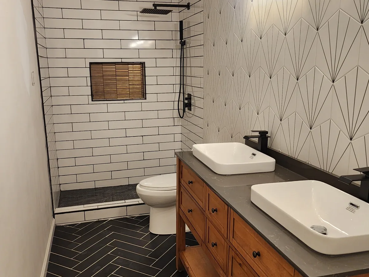 Subway tile shower and wood vanity in a remodeled bathroom