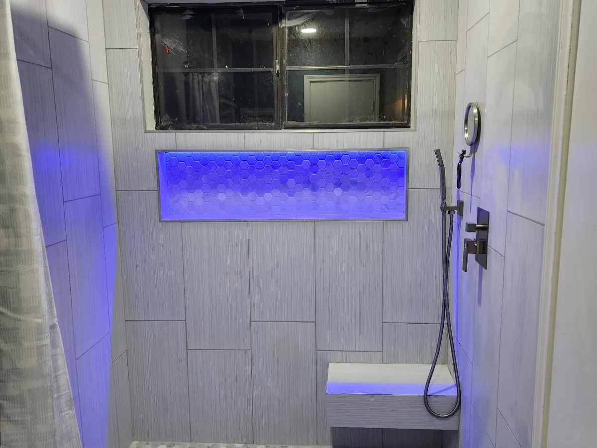 Tub to shower conversion with lit niche and tiled bench